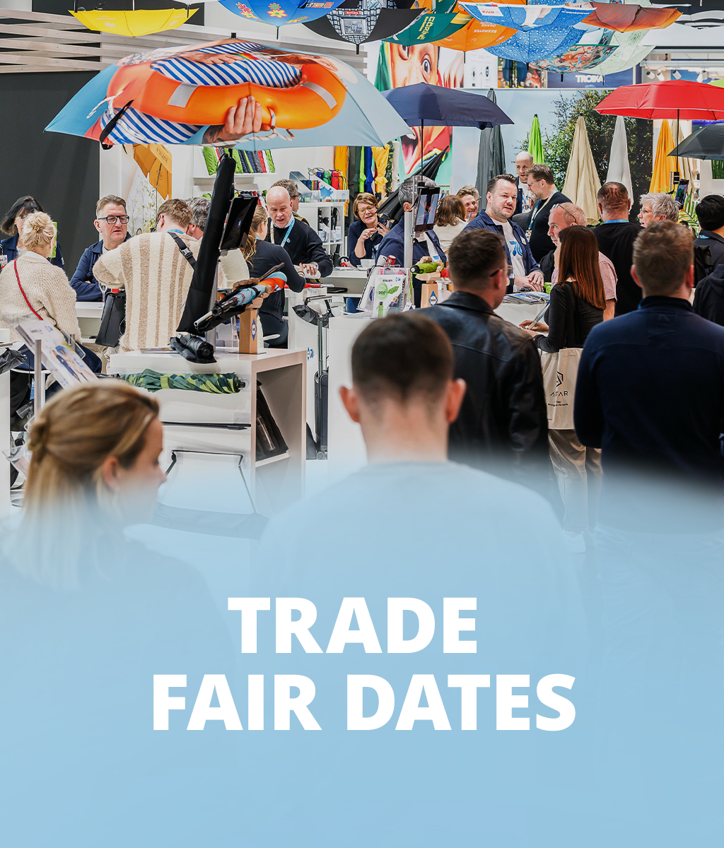 FARE trade fair booth with visitors, colorful umbrellas suspended above, and the text 'Trade Fair Dates' on a blue-white background.
